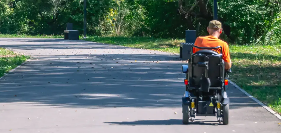 A man in a wheelchair enjoys the park