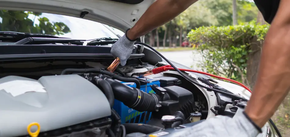 A man jump-starting a car