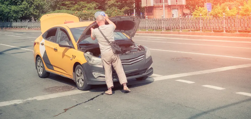 A man checking under the hood