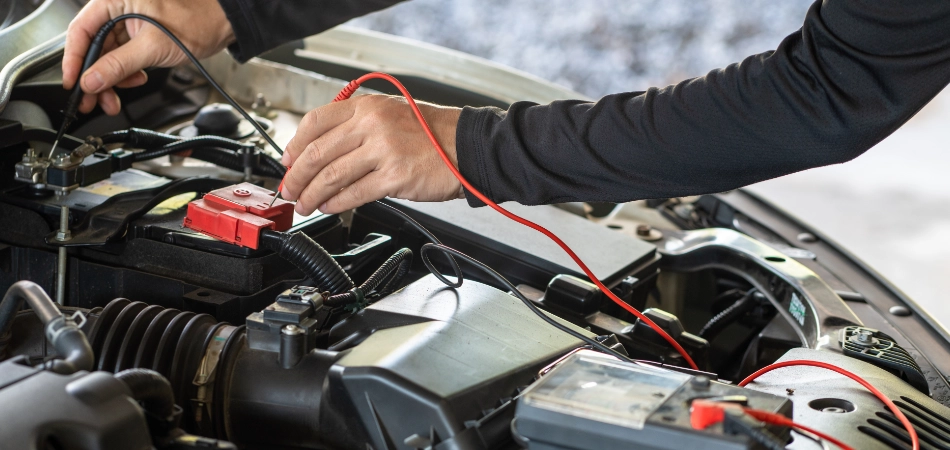 A man checks a car battery