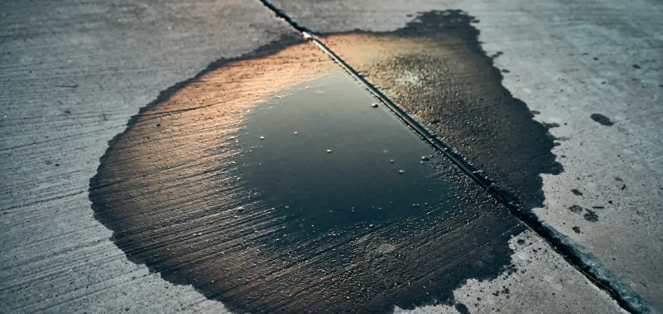 A puddle of battery acid on a driveway
